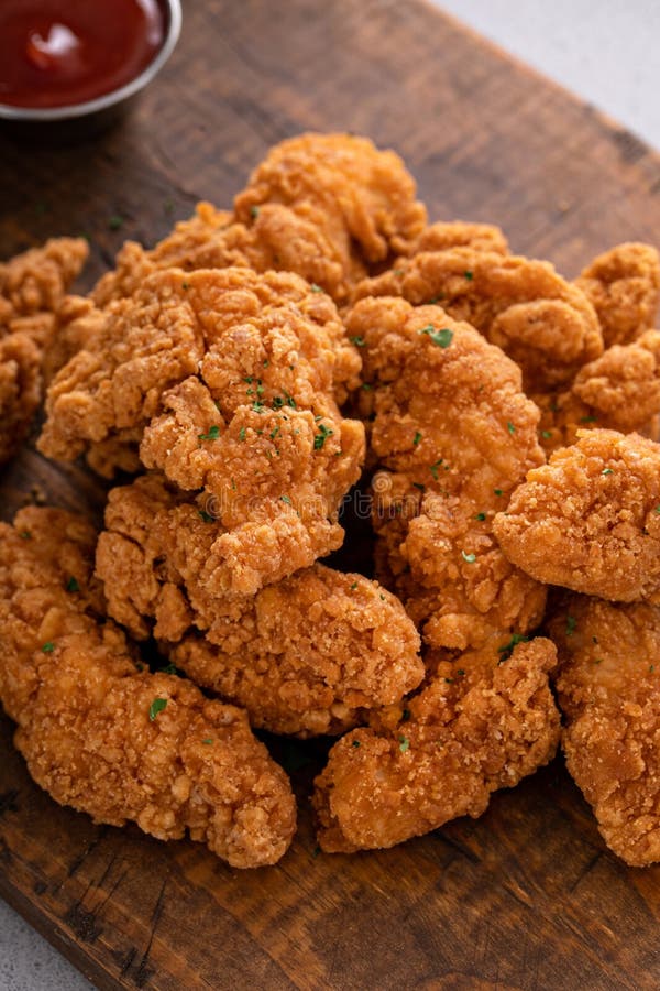 Fried Chicken Tenders or Strips with Sauces and Fries Stock Image