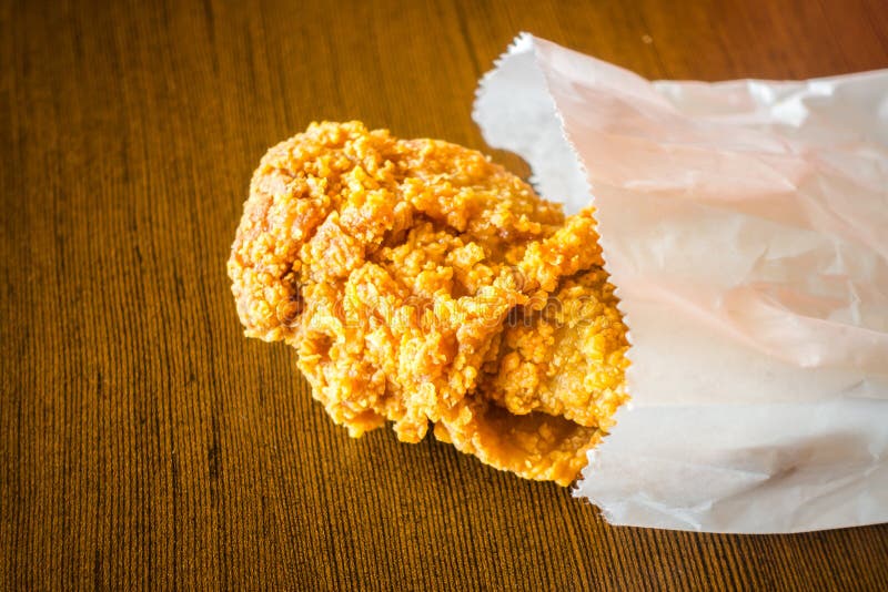 Fried Chicken Wings in Paper Bag on Wood Table . Stock Photo Image of