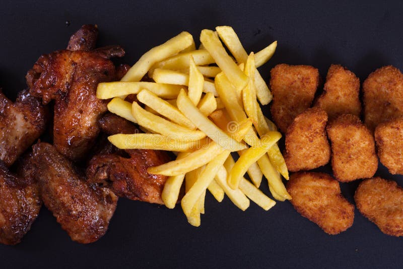 Fried Chicken Wings with a Side Dish of Potatoes Stock Photo Image of