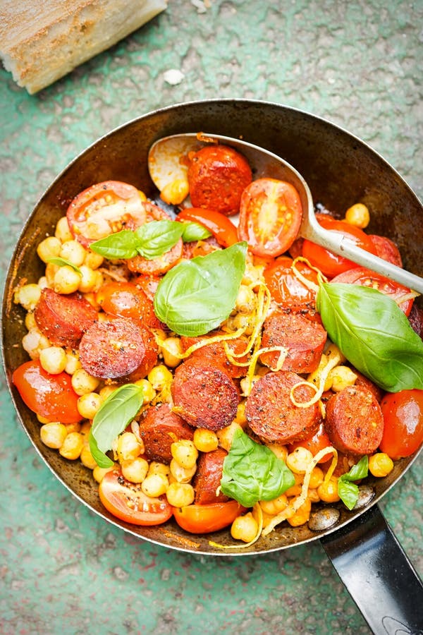 Fried Chorizo Sausage with Chickpeas, Tomatoes & Basil Stock Photo