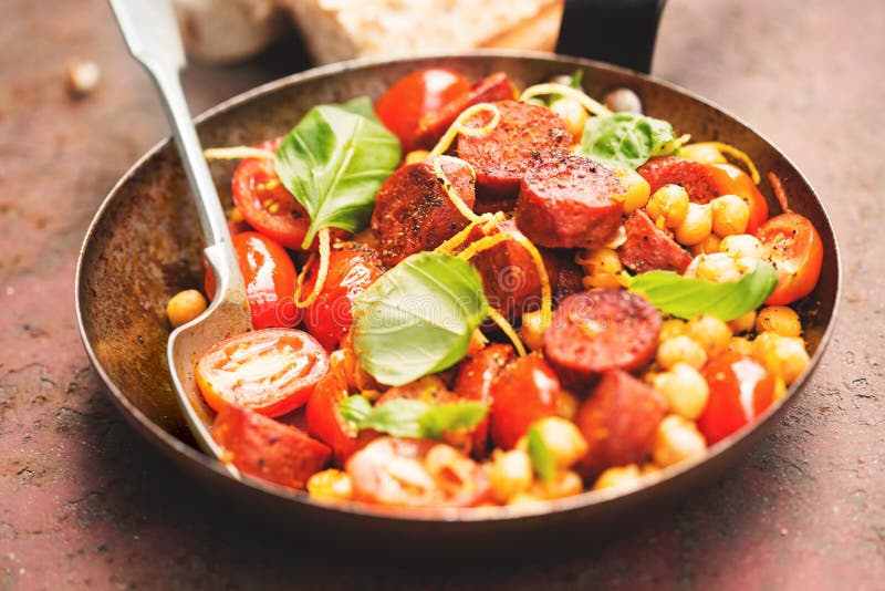 Fried Chorizo Sausage with Chickpeas, Tomatoes & Basil Stock Image