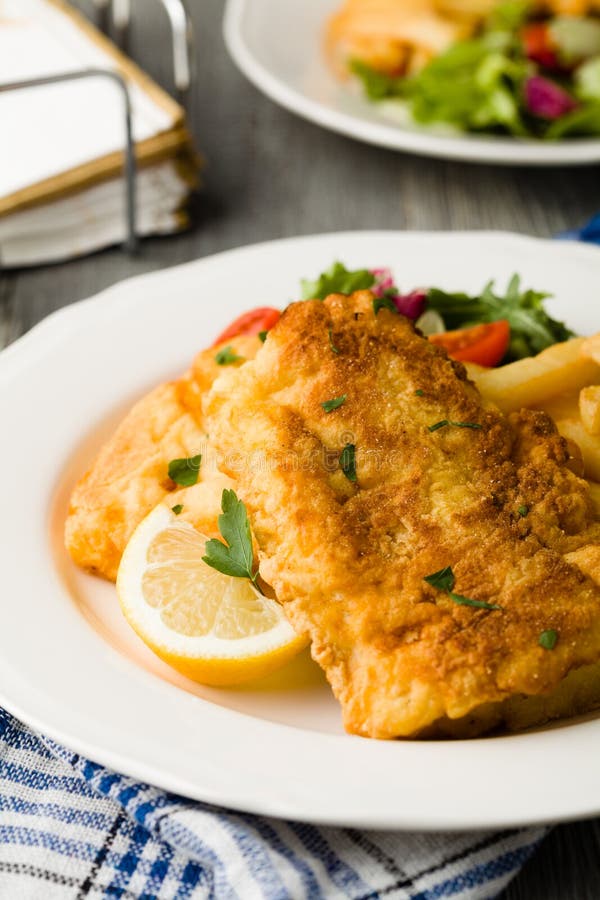 Fried Cod with Chips. Cod Fried in Breadcrumbs with Fries and Salad
