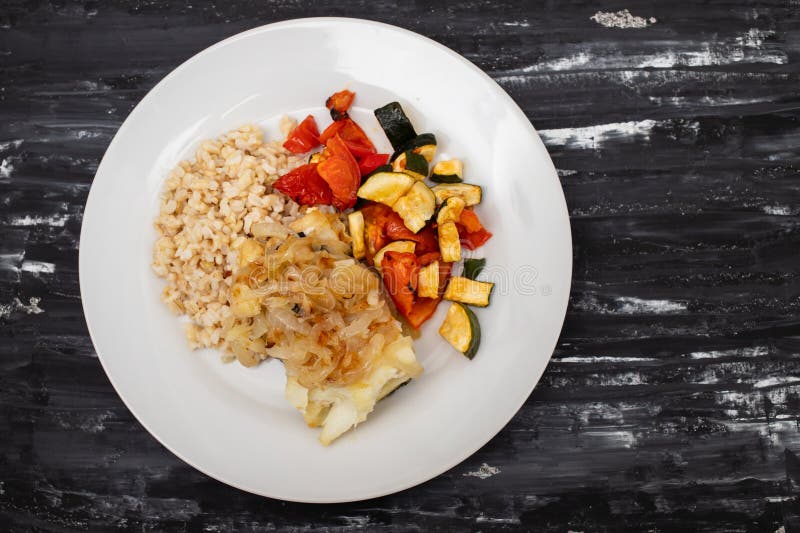 Fried Cod Fish with Onion, Vegetables, Rice and Olive Oil on Plate ...