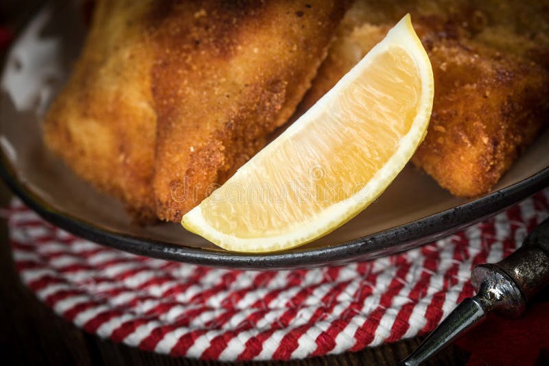 Fried cod slices in breadcrumbs. Small depth of field.