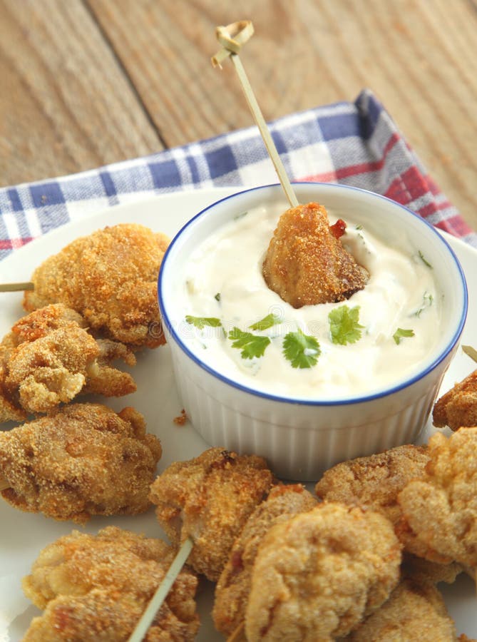 Fried Cornmealcrusted Chicken Bites with Yogurt Herb Dressing. Stock