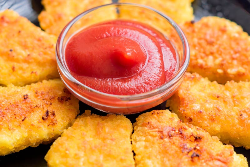 Fried Crispy Chicken Nuggets with Ketchup on Black Plate Stock Photo ...