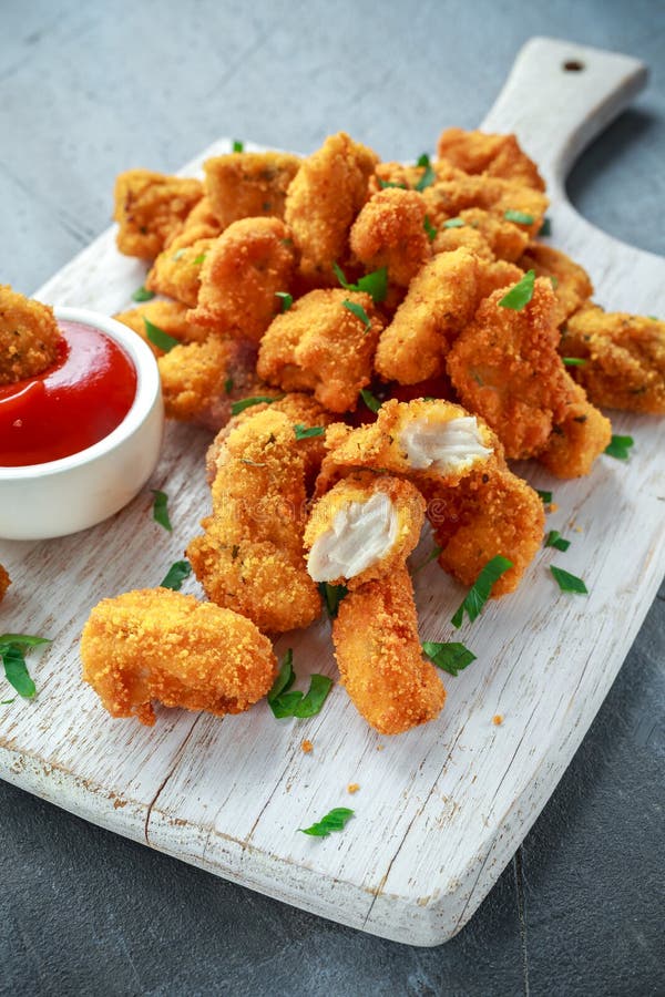 Fried Crispy Chicken Nuggets with Ketchup on White Board Stock Photo