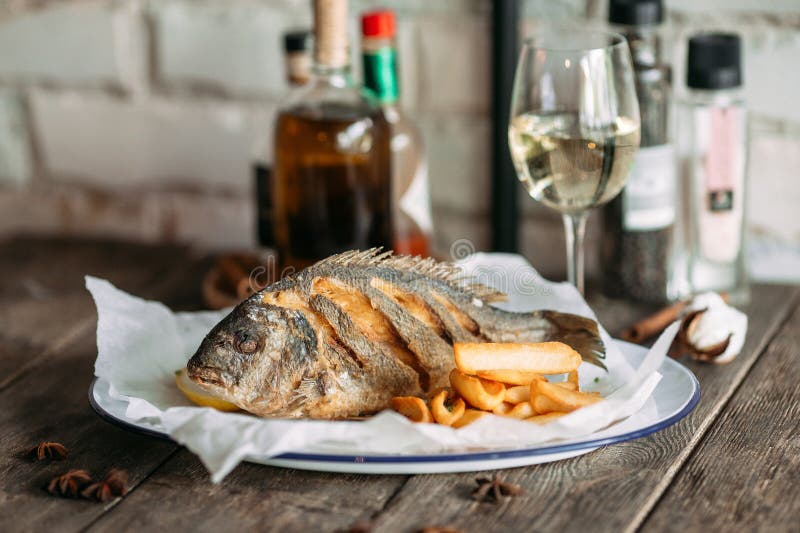 Fried Dorado Fish with Fries Chips and White Wine Stock Image Image