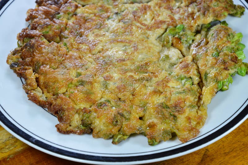 Fried egg crispy and fluffy on dish royalty free stock image