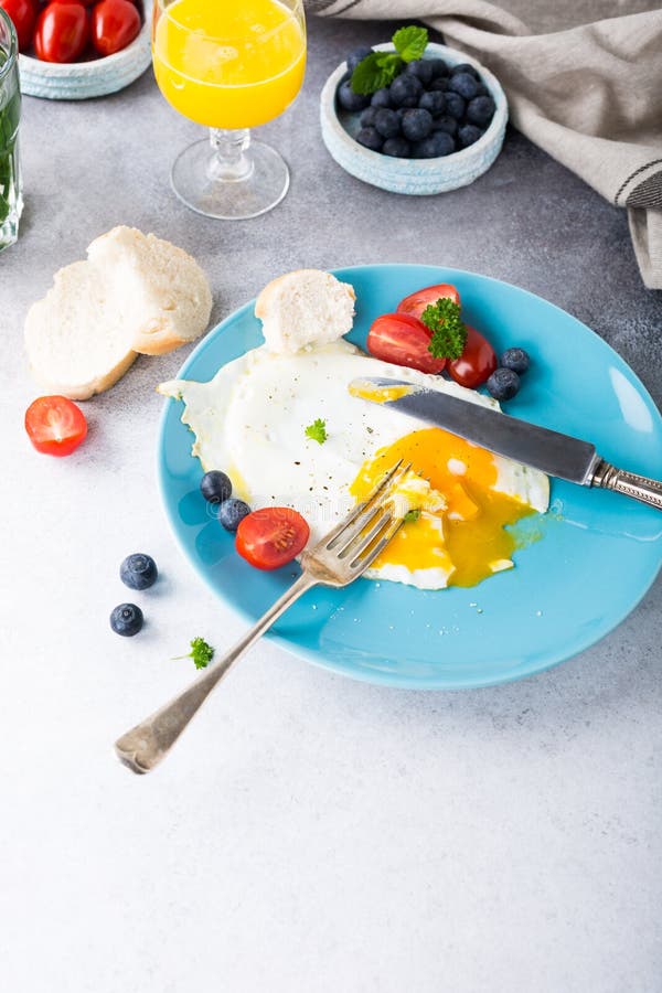 Fried egg and orange juice stock photo. Image of blue - 92537932