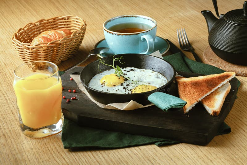 Fried Eggs Fried in a Frying Pan for Breakfast with Bread Stock Image