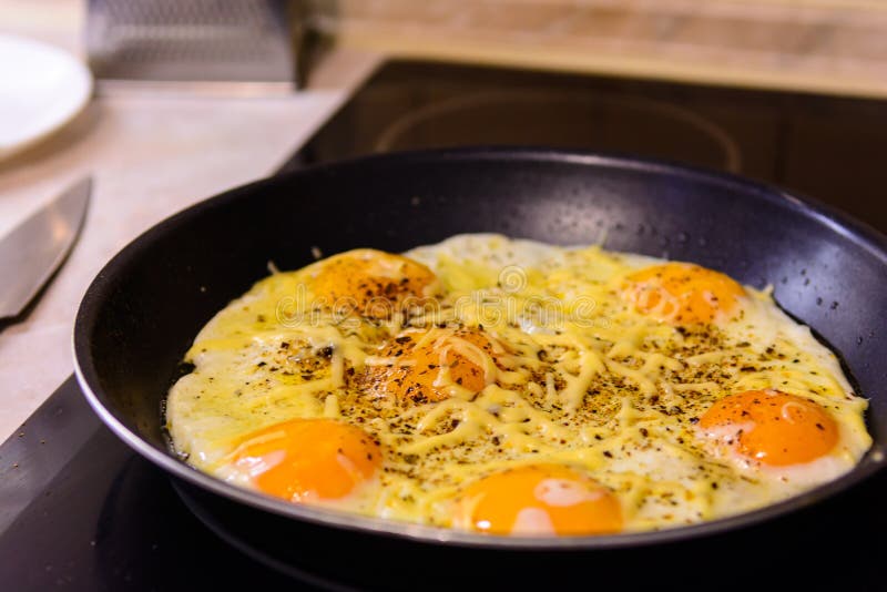 Fried Eggs in the Frying Pan with Cheese at Home. Stock Image Image