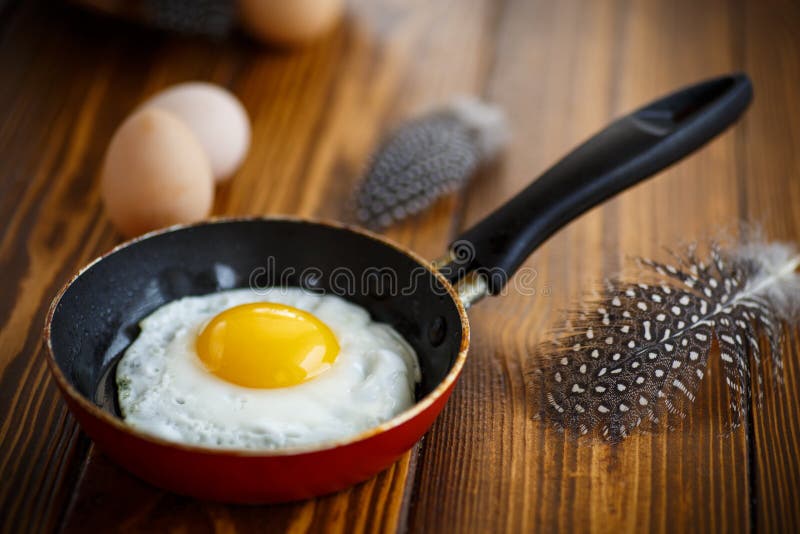 Fried eggs in a frying pan. Cooking, morning.