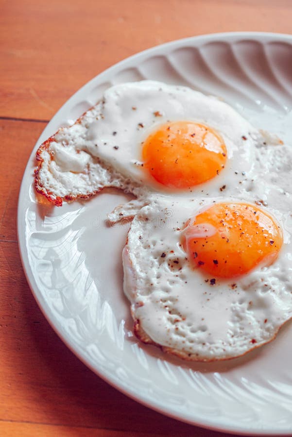 Fried Eggs with Salt and Pepper on a Plate Stock Photo Image of nourishment, meal 185496564