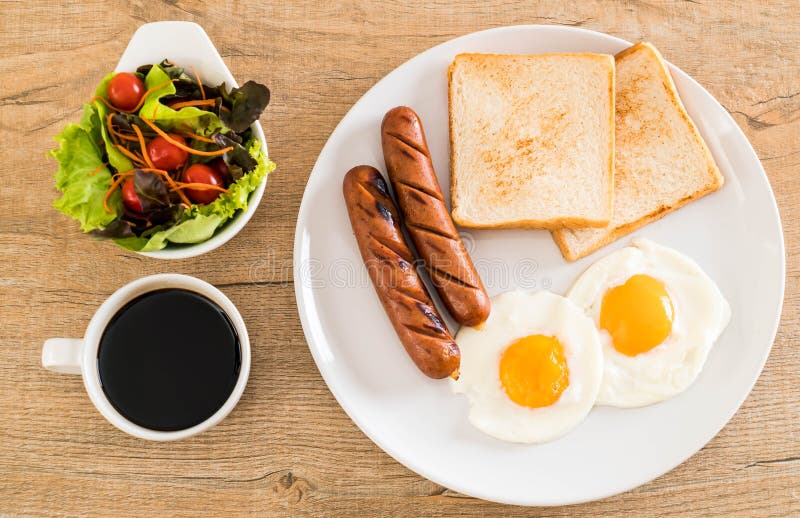 fried eggs with sausage and bread