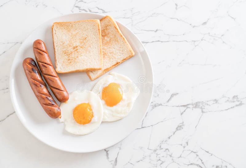 fried eggs with sausage and bread