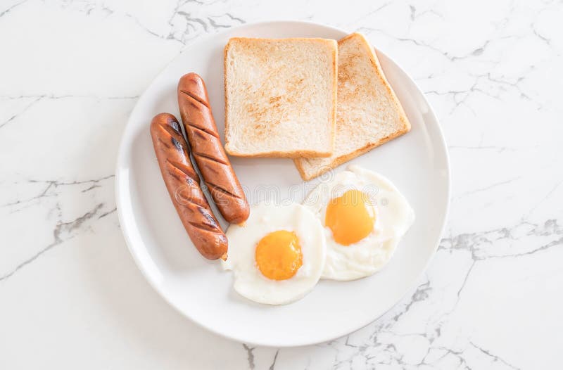 fried eggs with sausage and bread