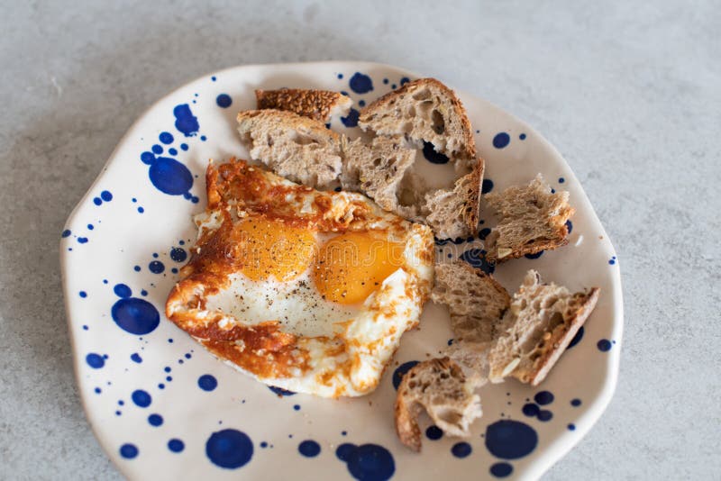 Fried Eggs with Sesame, Served with Sour Dough Toast Stock Photo