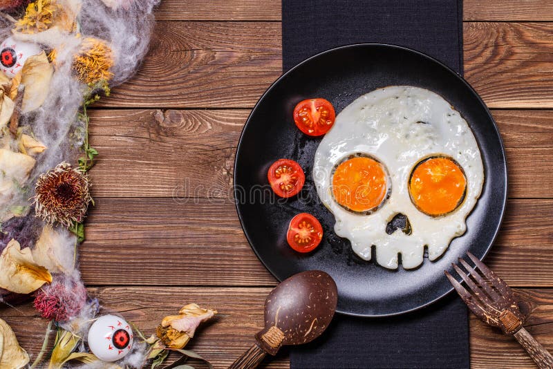 Fried Eggs in the Shape of a Skull and Fresh Tomatoes. Breakfast in