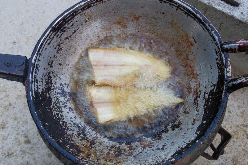 Fried fish on boiling oil stock photo. Image of cuisine 58381970
