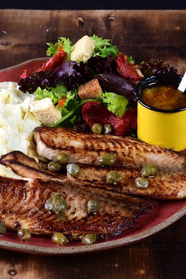 fried-fish-fillet-with-boiled-mashed-potatoes-and-salads-stock-photo