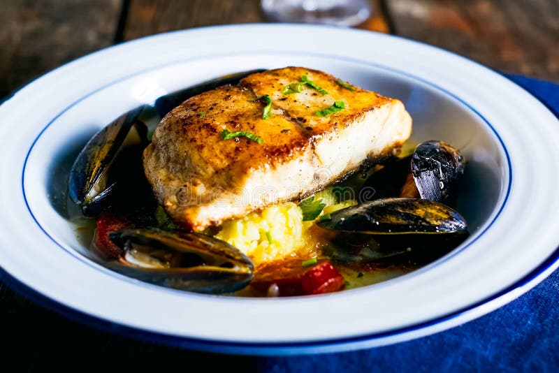 Fried Fish Fillet with Mussels in Plate on the Table Stock Photo