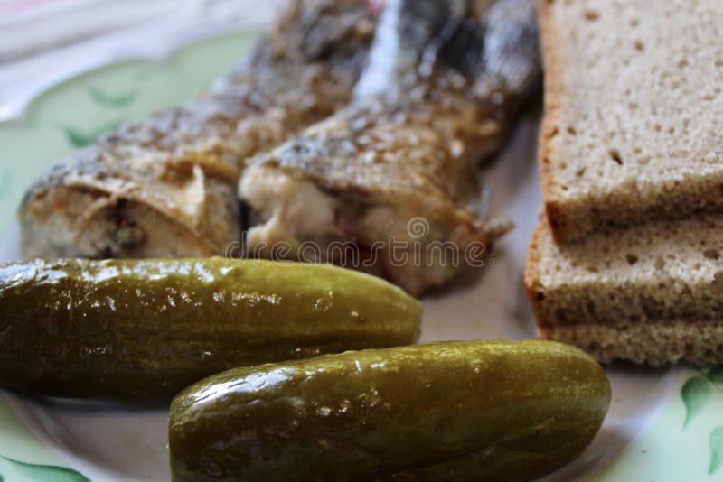 Fried Fish, Pickles and Slices of Bread on a Plate Stock Photo Image