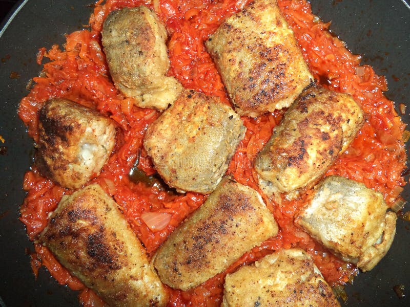 Fried fish slices with vegetables stock photo