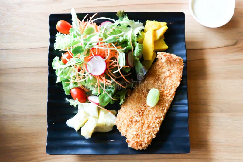 Fried Fish with Tomato Gravy and Salad or Fish and Chips Stock Image