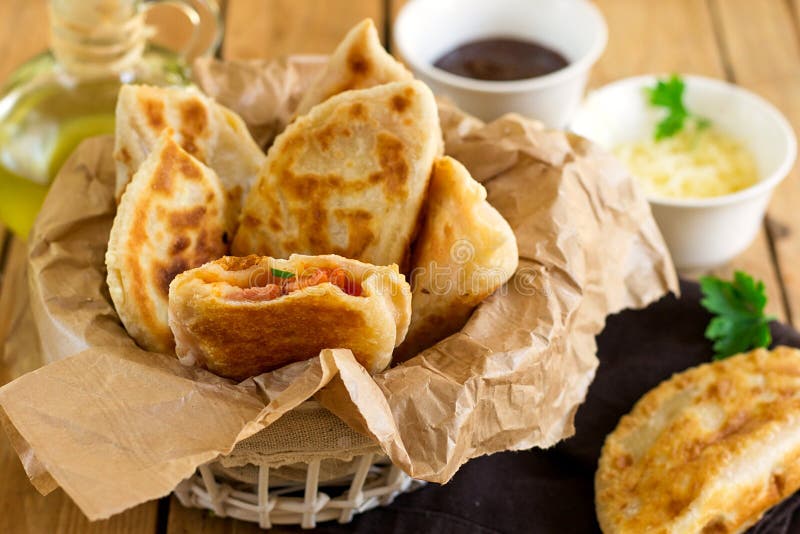 Fried Flatbread Filled with Ketchup, Cheese and Sausages Stock Photo