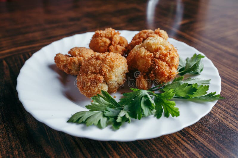 Fried Fresh Cauliflower in Breadcrumbs Closeup on a Plate Stock Image