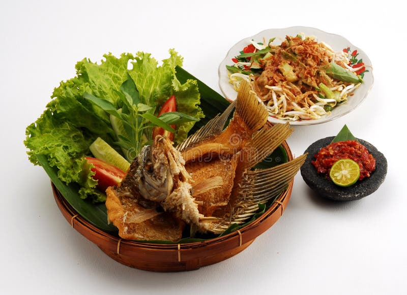 Closeup of fried gourami fish meal with side salads, isolated on white background. Crispy diet stock images, royalty-free photos and pictures