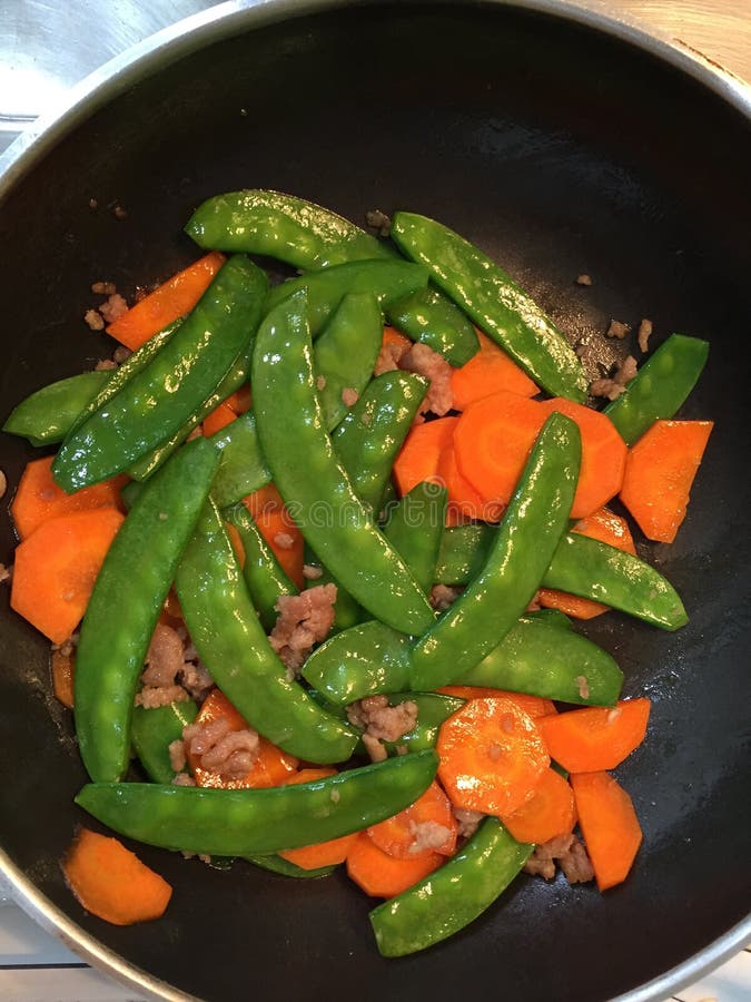 Fried green pea and carrot stock image. Image of menu 48649305