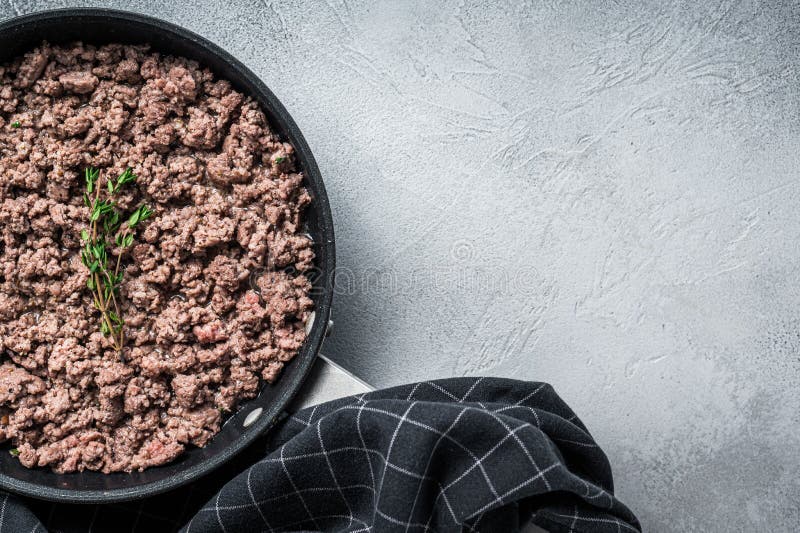 Fried Ground Mince Beef and Pork Meat in a Pan with Herbs. White