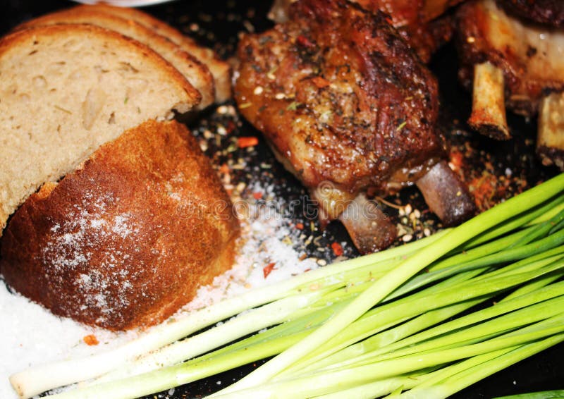Fried meat on a bone with spices stock photo Fried meat on a bone with spices stock photo
