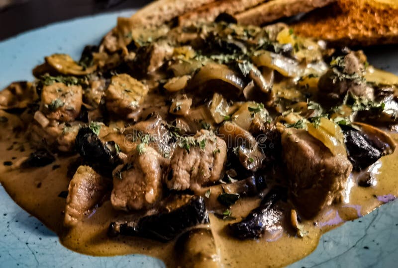 Fried meat with mushrooms stock photo. Image of soup 229128632