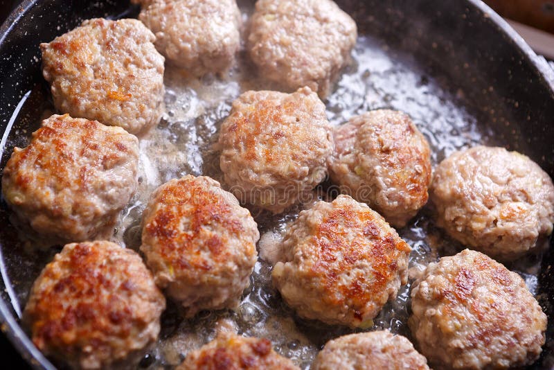 Fried Meat Patties are Cooked in a Pan in the Oil in the Kitchen Stock