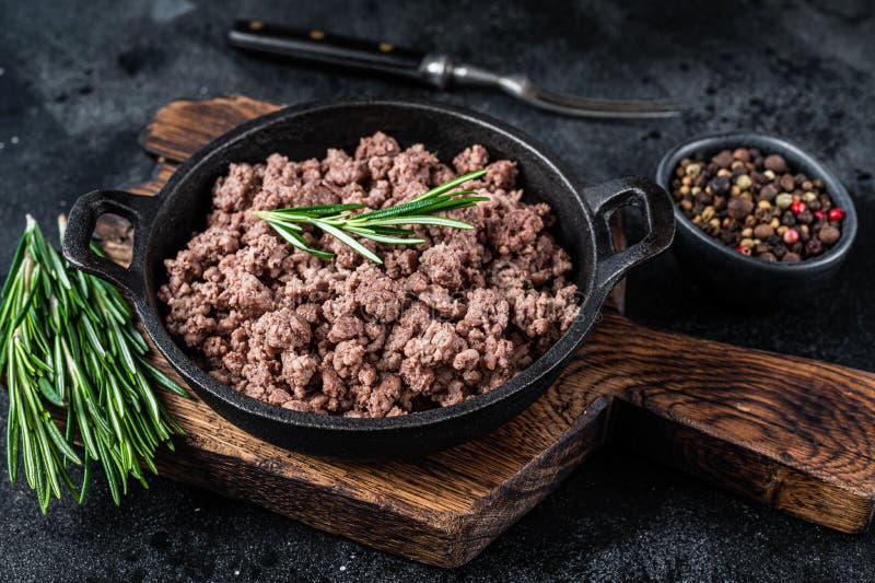 Fried Mince Beef and Lamb Meat in a Pan with Herbs. White Background
