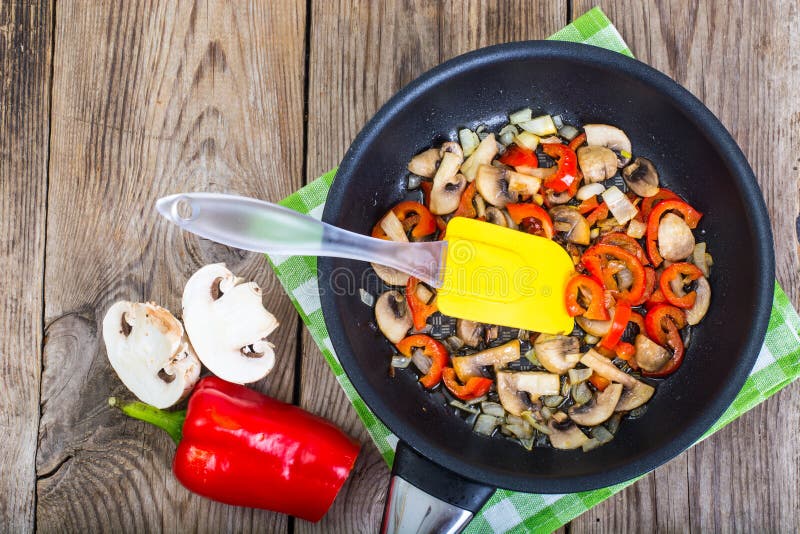 Fried Mushrooms With Peppers And Onions In The Pan. View From Ab