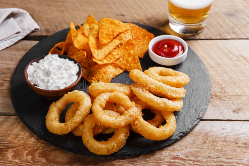 Fried Onion Rings in Batter with Sauce Tortilla Chips Stock Image