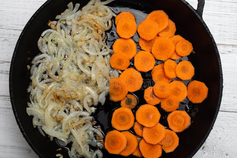 Fried Onions and Carrots in a Pan. Roasting Vegetables, Cooking