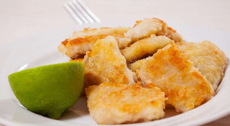 Fried pieces of fish fillets stock photography