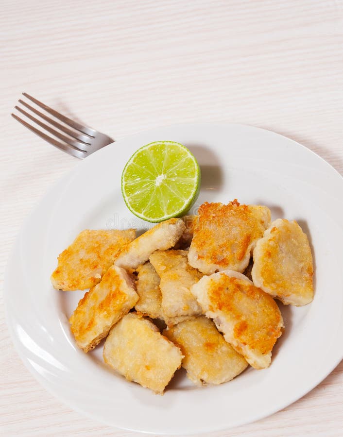 Fried pieces of fish fillets stock image