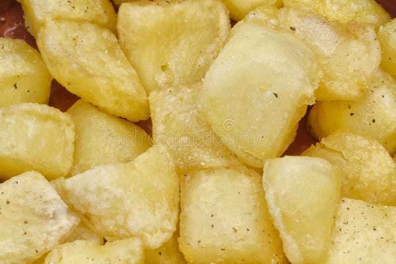 Fried pieces of potatoes stock photography