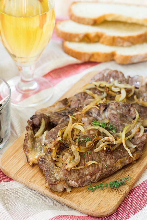 Fried pork chops with caramelized onions.