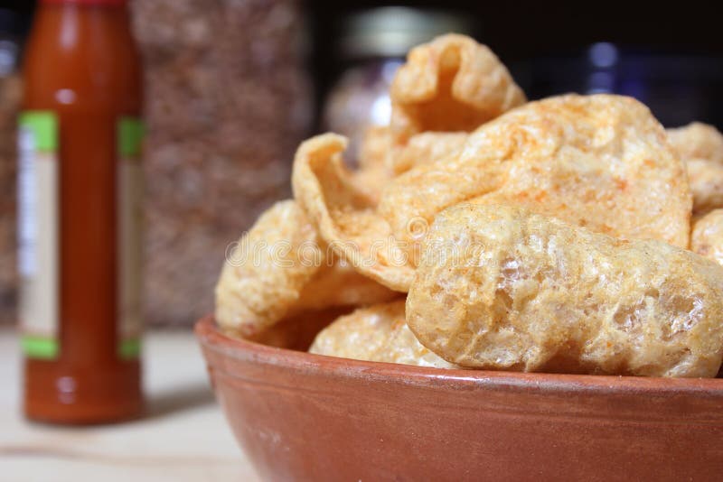 Fried Pork Skins with Hot Sauce in Rustic Kitchen Stock Photo Image