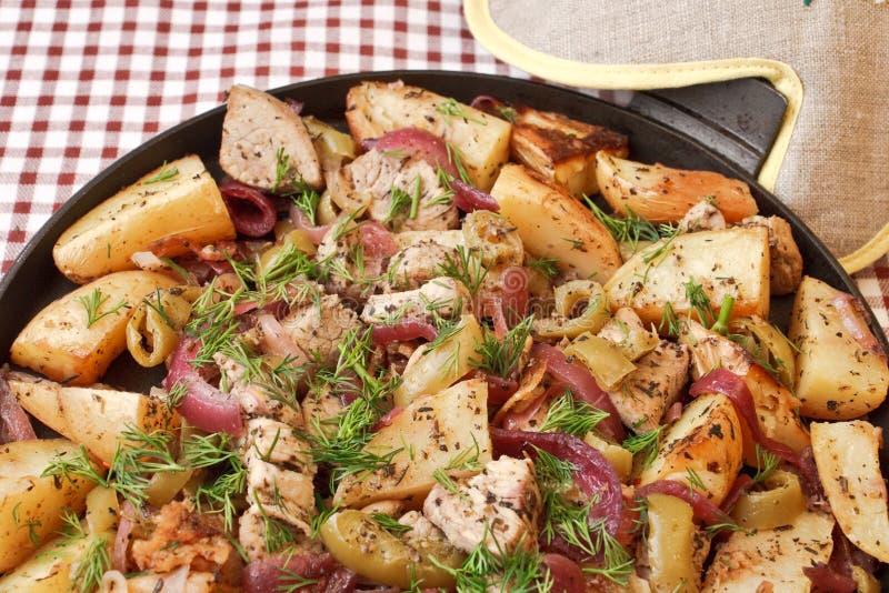 Fried potato with pork in a frying pan