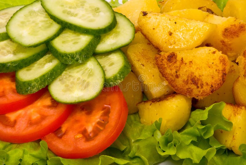 Fried potatoes with fresh cucumbers and tomatoes