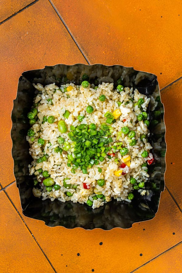 Fried Rice with Egg and Vegetables in Box Take Away. Orange Background