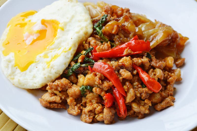 Fried Rice Noodle and Spicy Chop Pork with Basil Leaf Topping Egg Stock